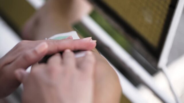 Depilating woman smooth leg with wax strip
