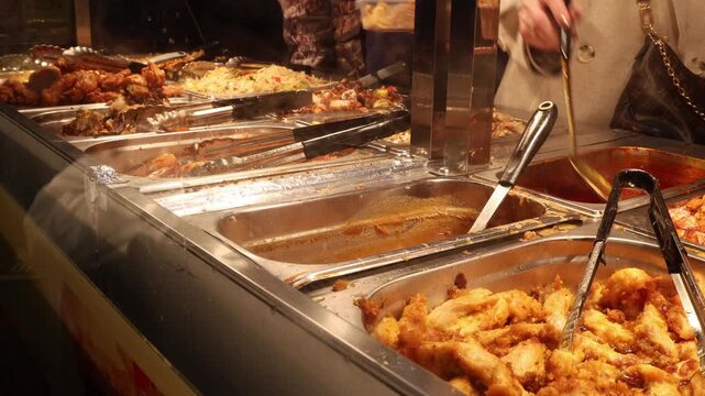 Fast food buffet in Chinese restaurant, people taking food