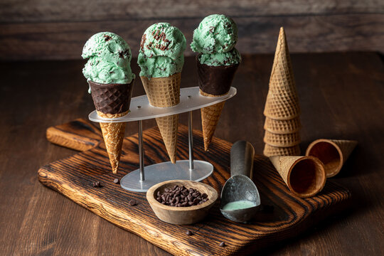 Chocolate chip mint ice cream cones in a stand, ready for eating.