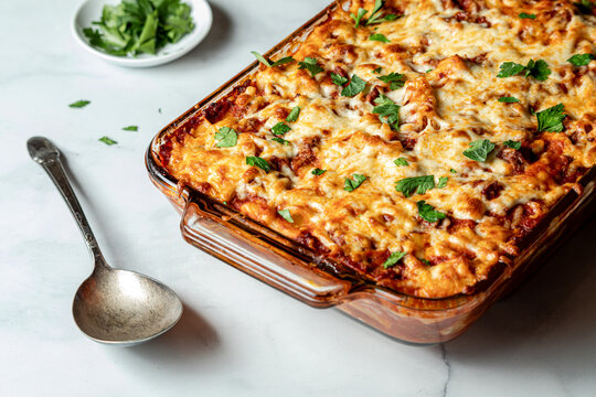 Homemade baked ziti hot out of the oven, ready for serving.
