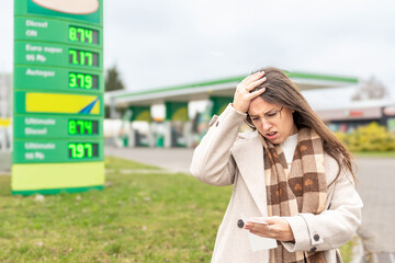 Personal finance pressure woman reviewing fuel purchase © Maksym