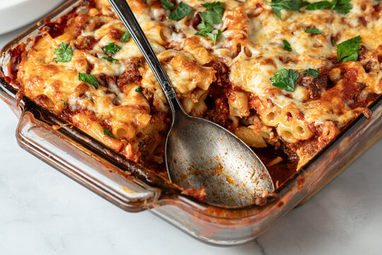 A baking dish filled with homemade baked ziti, ready for serving.