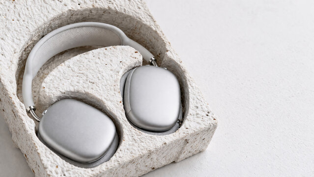 Modern wireless over-ear headphones inside molded biodegradable eco-friendly paper pulp packaging.