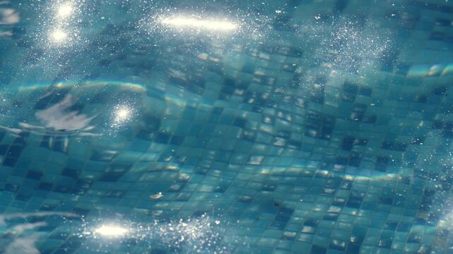 Seamless texture of blue pool water surface with sun reflections and ripples, slow motion background