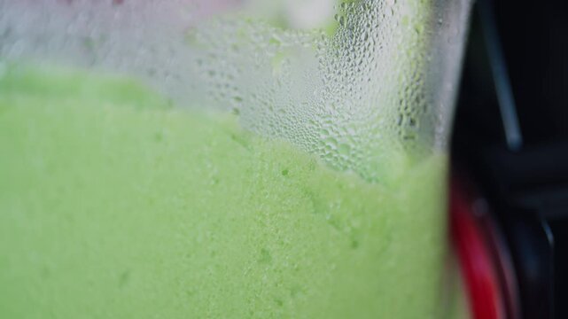 Colorful frozen smoothie slushy in a Carnival Machine, slow motion