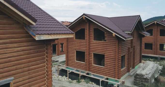 Drying and assembly of wooden log house at a construction base, industrial backgorund, aerial view