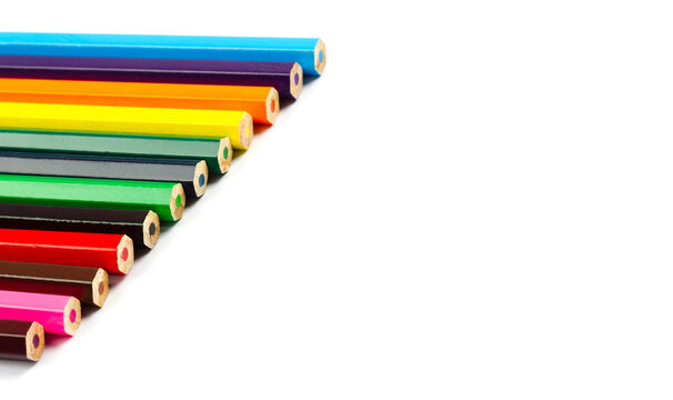 Colored pencil ends in row with copy space on white