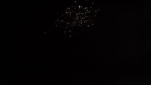 Golden Spark Particles Rising Upward on Dark Background Abstract Luxury Glitter Energy Floating Motion Elegant Light Dust Celebration Atmosphere