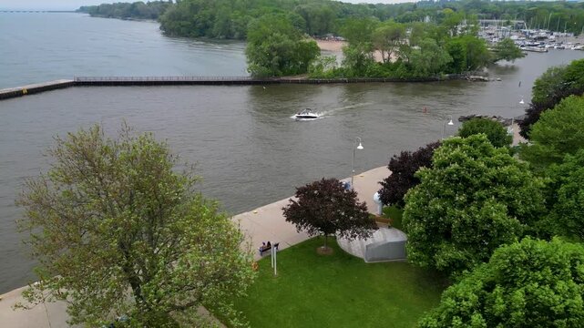 Aerial view of small motorboat cruising near Bronte Harbour waterfront.mp4