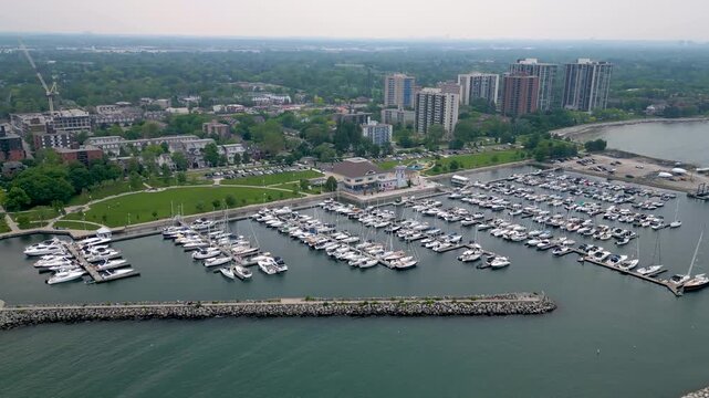 Aerial panoramic view of Bronte Harbour marina and waterfront skyline in Oakville.mp4