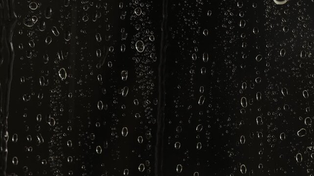Wet glass with dripping water drops, closeup