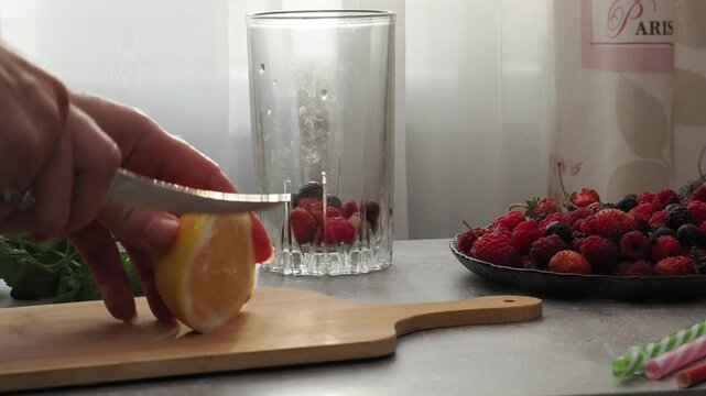 Summer drinks, colored cocktails on table. Lemonade, mojito, strawberry lemonade, tonic water. A refreshing summer drink with raspberries and blueberries, a detox drink for weight loss and keeping fit