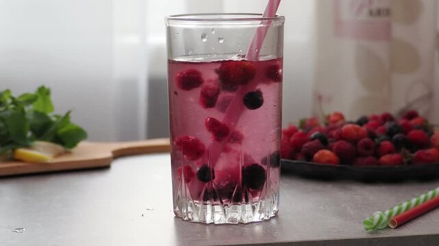 Summer drinks, colored cocktails on table. Lemonade, mojito, strawberry lemonade, tonic water. A refreshing summer drink with raspberries and blueberries, a detox drink for weight loss and keeping fit