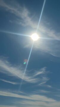 The strong sunlight shining in the blue sky and flowing clouds