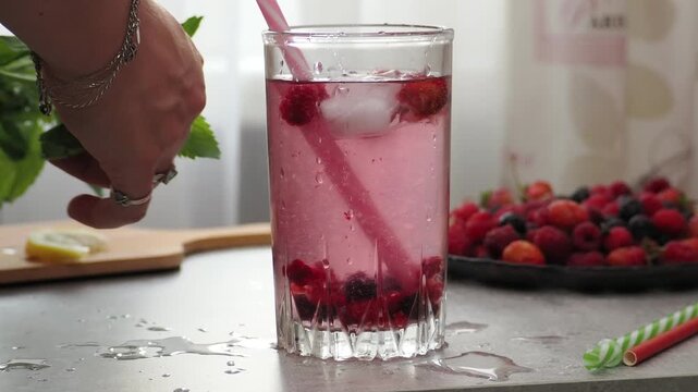 Summer drinks, colored cocktails on table. Lemonade, mojito, strawberry lemonade, tonic water. A refreshing summer drink with raspberries and blueberries, a detox drink for weight loss and keeping fit
