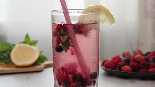 Summer drinks, colored cocktails on table. Lemonade, mojito, strawberry lemonade, tonic water. A refreshing summer drink with raspberries and blueberries, a detox drink for weight loss and keeping fit