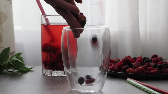 Summer drinks, colored cocktails on table. Lemonade, mojito, strawberry lemonade, tonic water. A refreshing summer drink with raspberries and blueberries, a detox drink for weight loss and keeping fit