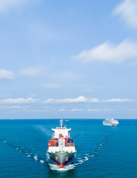 large container ship sailing in the deep blue ocean under a clear sky. Concept of global maritime logistics, international freight transport, and trade supply chain.