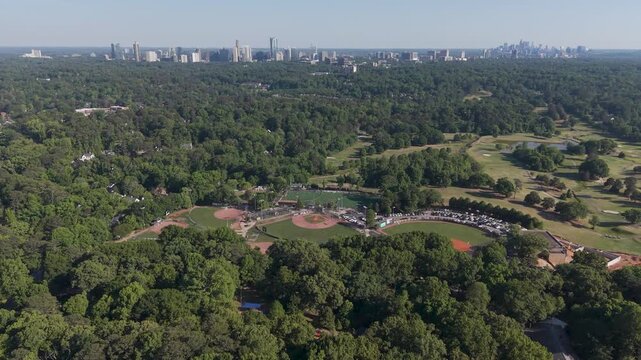 Chastain Park aerial push toward Buckhead skyline in Atlanta