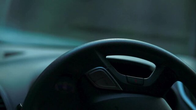 View of steering wheel and control panel vehicle interior. Control buttons on the steering wheel of the car, closeup. Fragment of car dashboard with steering wheel.
