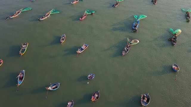 Vietnam, Da Nang Unified Crews Handle Nets Skillfully. Aligned Sailors Operate Round Boats Efficiently. Maritime Workers Coordinate Their Efforts To Cast Nets From Circular Boats Near Da