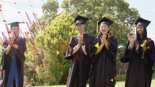 Graduates in caps gowns lining on lawn, peer running forward causing peers clapping, stepping right