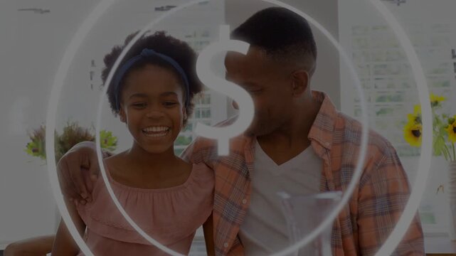 Father placing arm around daughter as dollar sign overlay appearing, teaching finance in kitchen