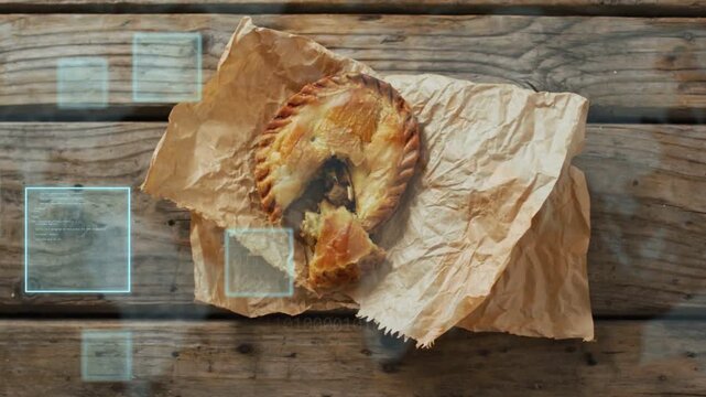Blue HUD squares appearing left drifting over wood while pie sitting on paper for product focus