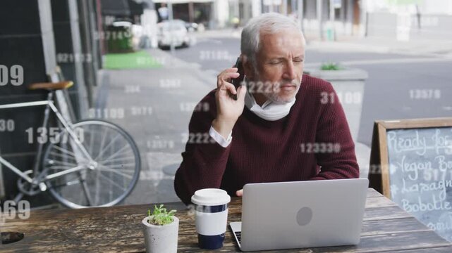 Remote worker man tapping smartphone then taking call at cafe, data overlay showing business stats