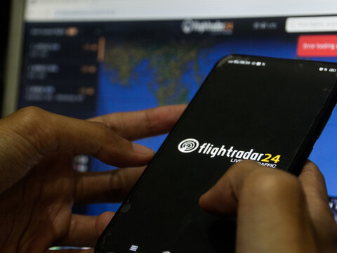 Klaten, Central Java - Indonesia - Jun 28 2024: A person accesses the Flightradar24 application via mobile phone, a global flight tracking service that allows real-time tracking of aircraft movements.