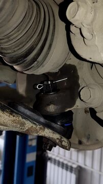 New silver cotter pin inserted into a black castle nut.