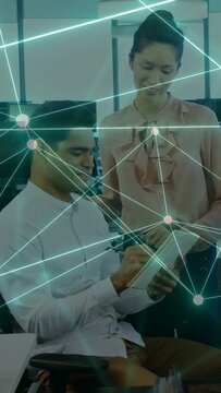 Vertical video: Business team tapping tablet with stylus, annotating for review as nodes sweeping