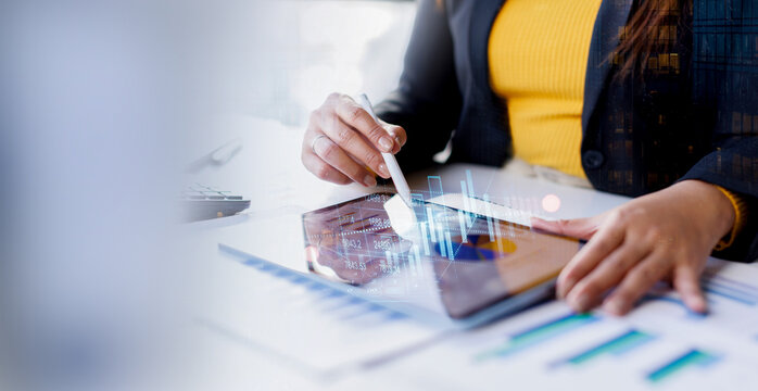 Businesswoman analyzing financial growth charts on digital tablet in office Corporate executive reviewing digital dashboard with interactive financial statistics