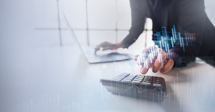 Businessman using calculator and laptop with financial charts financial data and accounting rand calculator Insight stock market data overlays