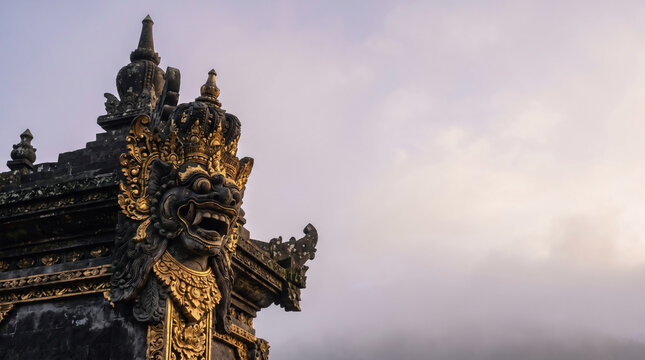 Ancient Balinese Hindu Temple Guardian Statue with Gold Ornaments in Misty Morning Fog