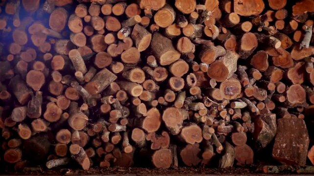 neatly onto one eachother warm dark typical brown wood color stacked wood Firewood texture background Preparation of firewood for the winter.