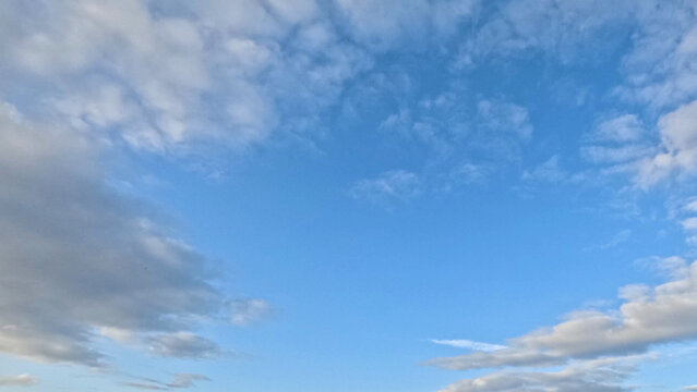 Wide Angle View of White and Grey Clouds Across Blue Sky