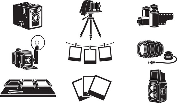 A collection of black and white featuring vintage equipment, including box cameras, bellows cameras on tripods, rolls, frames on a string, lenses, and darkroom trays