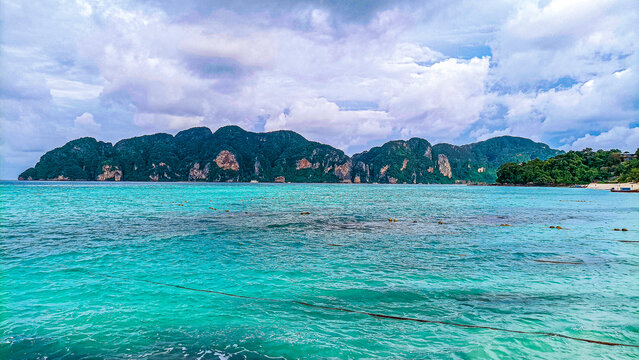 Phi Phi Island on August 15, 2025: Tropical landscape with turquoise water and cloudy sky