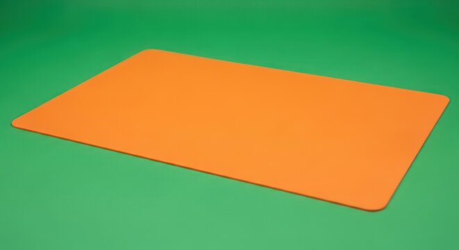 Bright Orange Rectangular Mat on a Green Background.