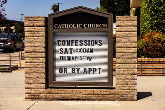 A sign at a Catholic church indicating that confessions can be made on certain days or by appointment