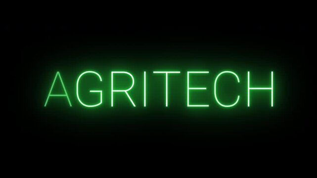 Flickering neon green agritech sign animated on black background.