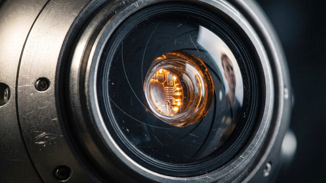 Macro of robot eye lens reflecting human face