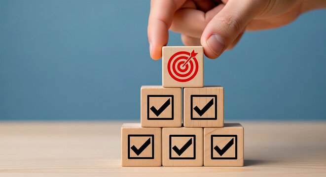 Reaching the bullseye: a hand places the target block on the completed goal blocks, representing success and goal achievement.