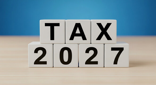 Tax 2027: Conceptual depiction of the word tax combined with the year 2027, presented on a wooden surface with a soft blue backdrop, symbolizing a fiscal year.