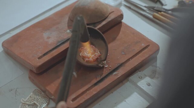 Extreme Close-up of Melting Raw Silver Scraps in a Ceramic Crucible with Gas Torch