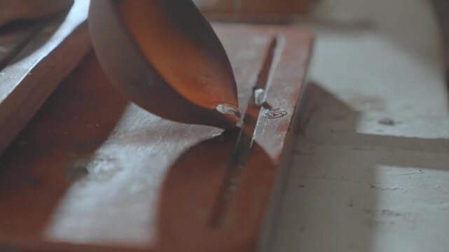 Silversmith Casting Hot Liquid Silver for Jewelry Production