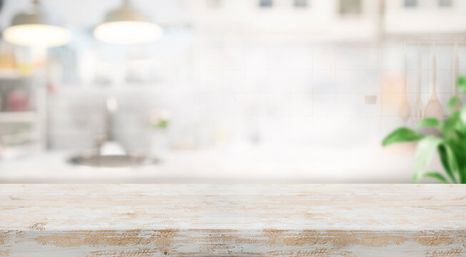Selective focus.White rustic wood table island with cozy white wall kitchen background for design product shot