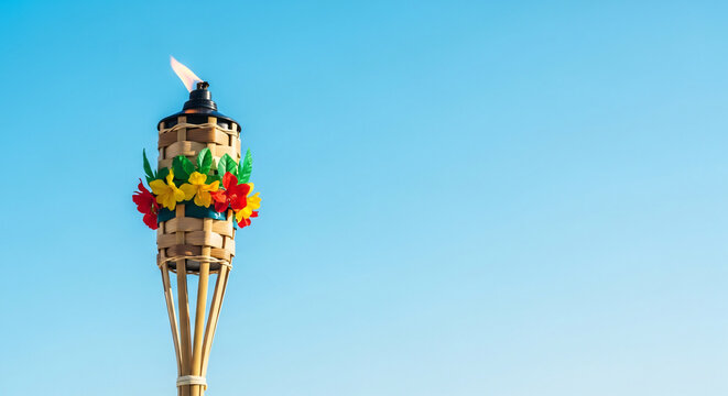 Bamboo Tiki Torch with Flame Against Clear Blue Sky