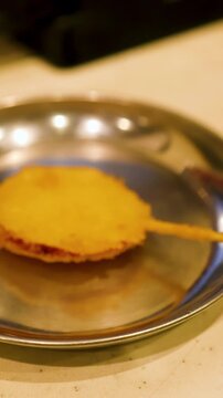 Japanese Kushikatsu Deep Fried Skewers Placed on a Metal Plate